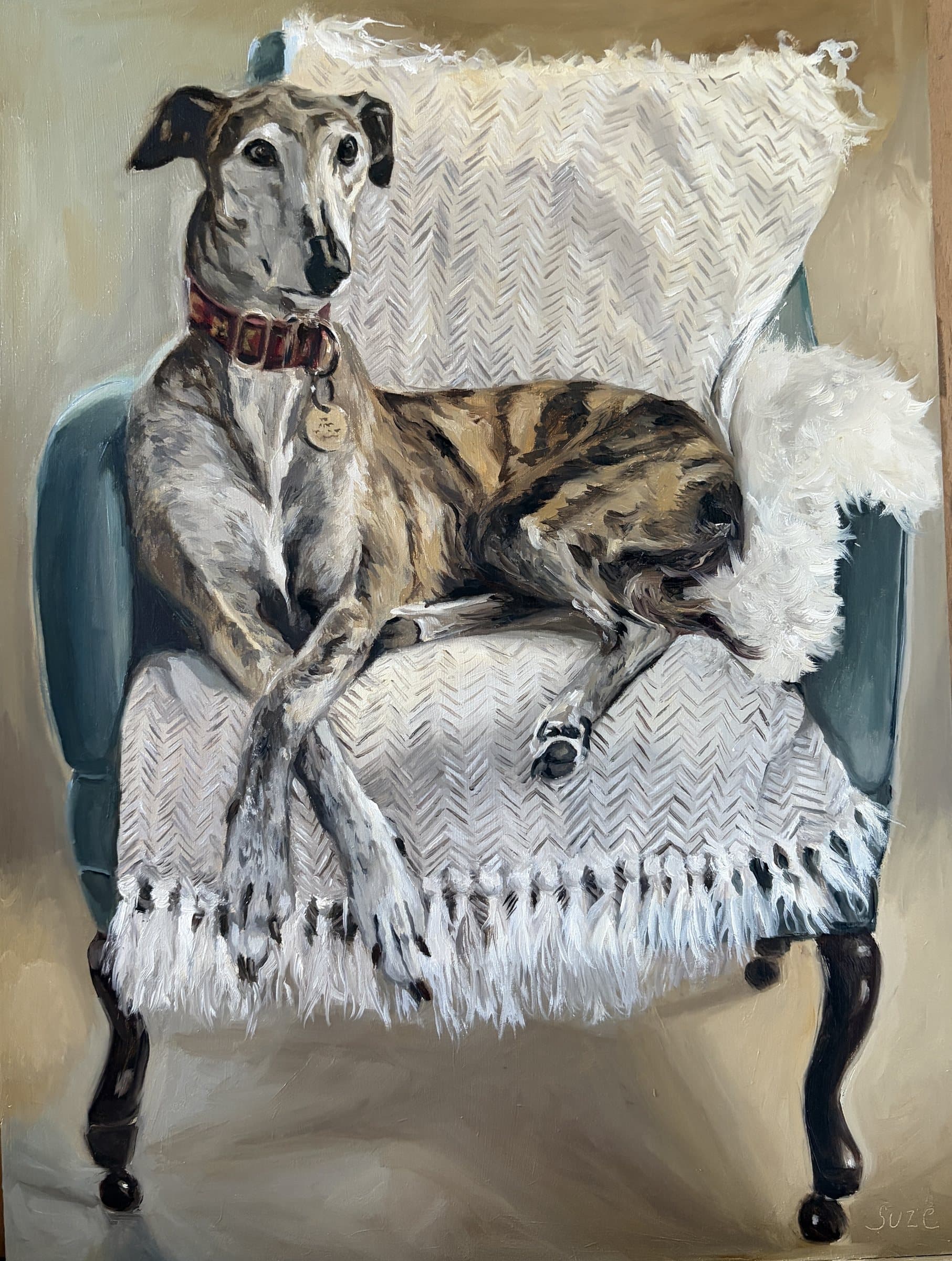 Painting of a tabby cat curled up beside a greyhound on an armchair